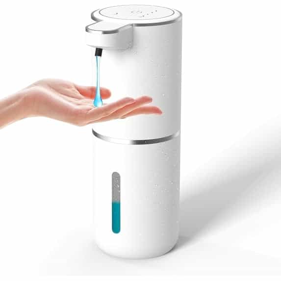 A white automatic touchless liquid soap dispenser dispensing blue soap into a hand against a clean white background.