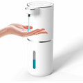 A white automatic touchless liquid soap dispenser dispensing blue soap into a hand against a clean white background.