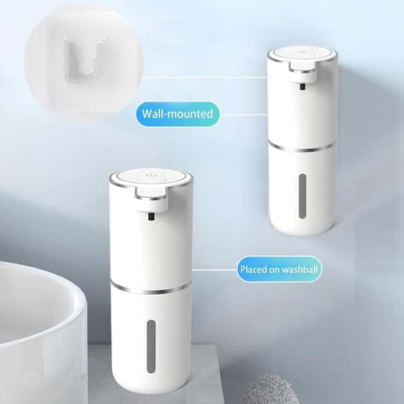 A white automatic soap dispenser shown wall-mounted and placed on a bathroom counter with a close-up of the mount bracket.